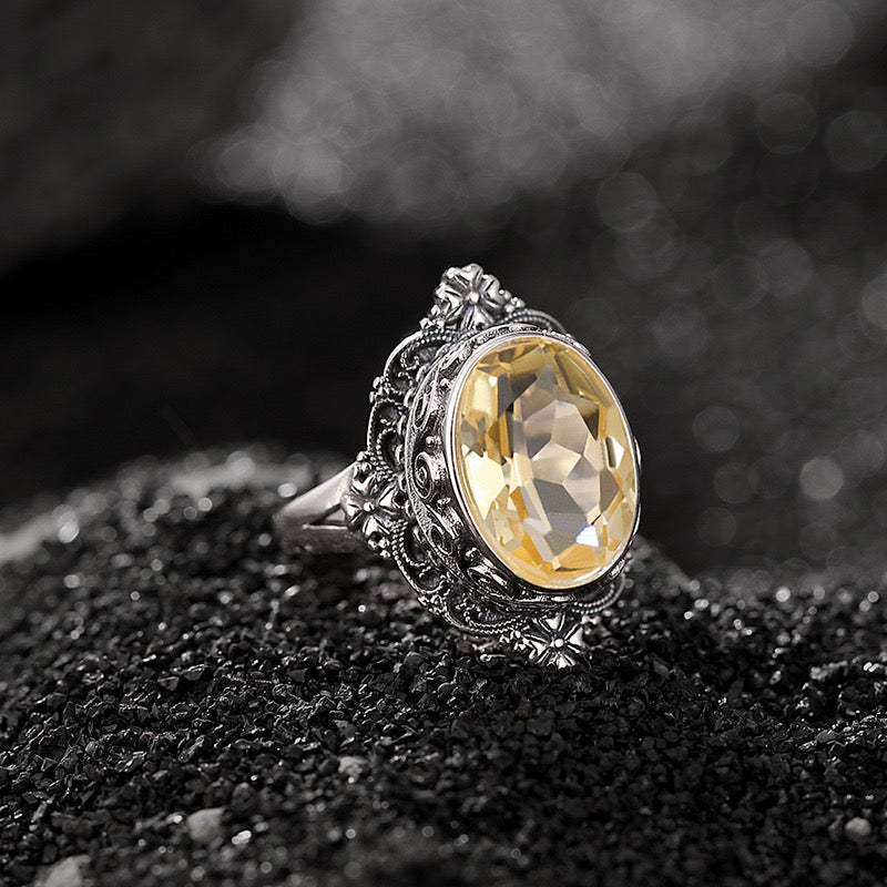 Bague princesse mystérieuse en argent avec une grande citrine ovale sertie dans un design détaillé et ouvragé.