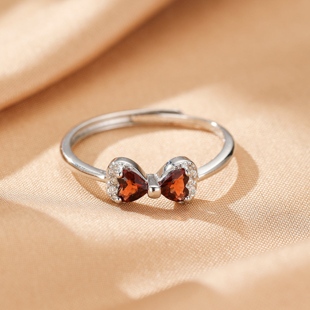 Bague nœud en argent 925 sertie de grenats et d'oxydes de zirconium