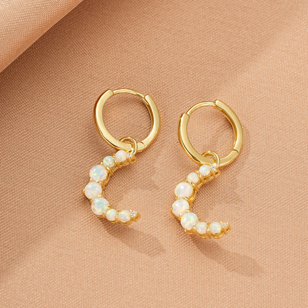 Paire de boucles d'oreilles créoles en argent 925 plaqué or 18 carats ornées d'opales blanches formant un croissant de lune.