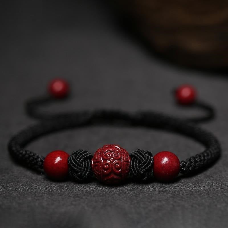 "Tibetan Love" in black with red Cinnabar on a grey tablecloth