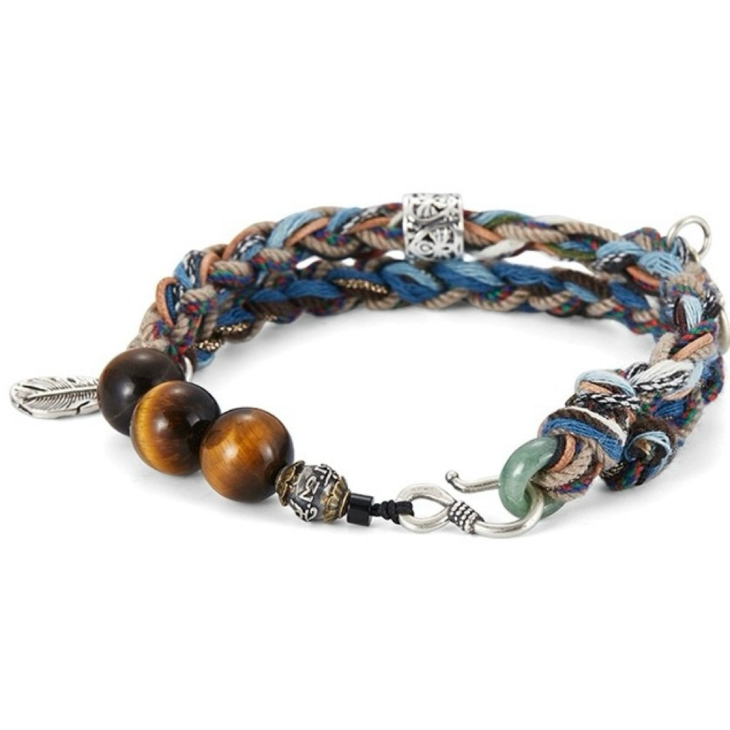 Bracelet tressé aux fils multicolores bleus et beiges, orné de trois perles d'œil de tigre, d'une breloque plume argentée et d'un fermoir mousqueton original.