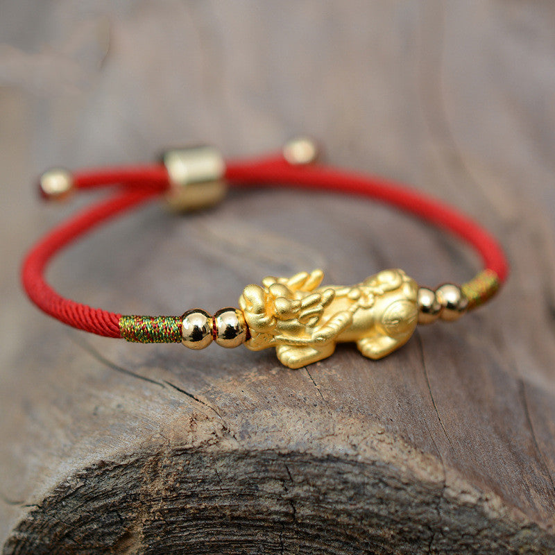 The "Mythique" bracelet placed on a tree stump
