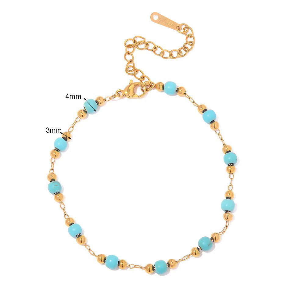 Bracelet Horizon Ancien en or avec des perles turquoise de 4 mm et des perles dorées de 3 mm, fermoir mousqueton et chaîne d'extension.