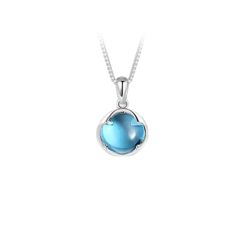 Collier en argent 925 avec un pendentif rond en aigue-marine bleue, symbolisant la sérénité.