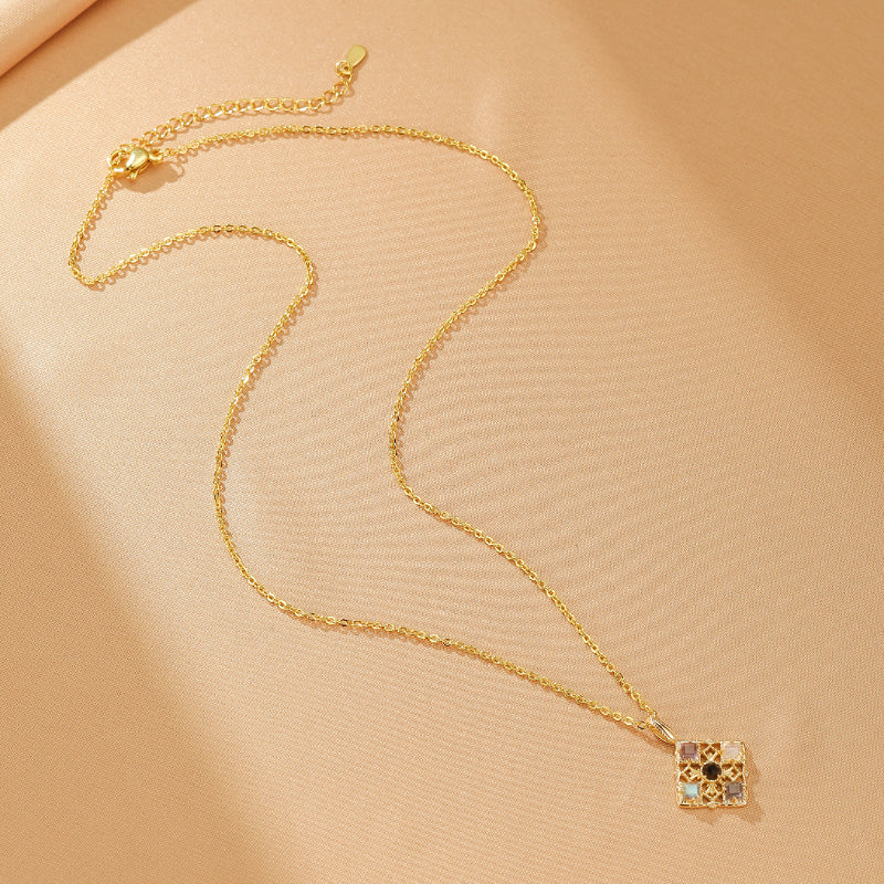 Collier chaîne fine en argent plaqué or avec un pendentif carré composé de petites pierres colorées, dont améthyste, labradorite et pierre de lune, en mosaïque.