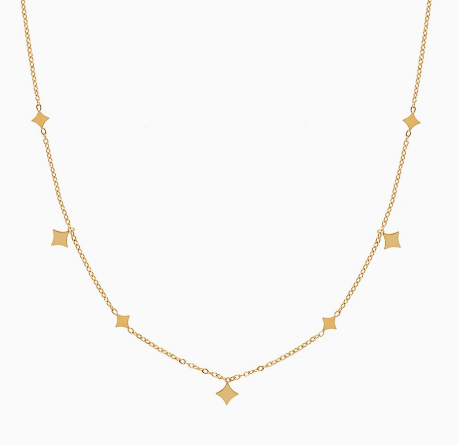 Collier fin en or jaune avec des petits pendentifs en forme d'étoile de mer répartis le long de la chaîne.