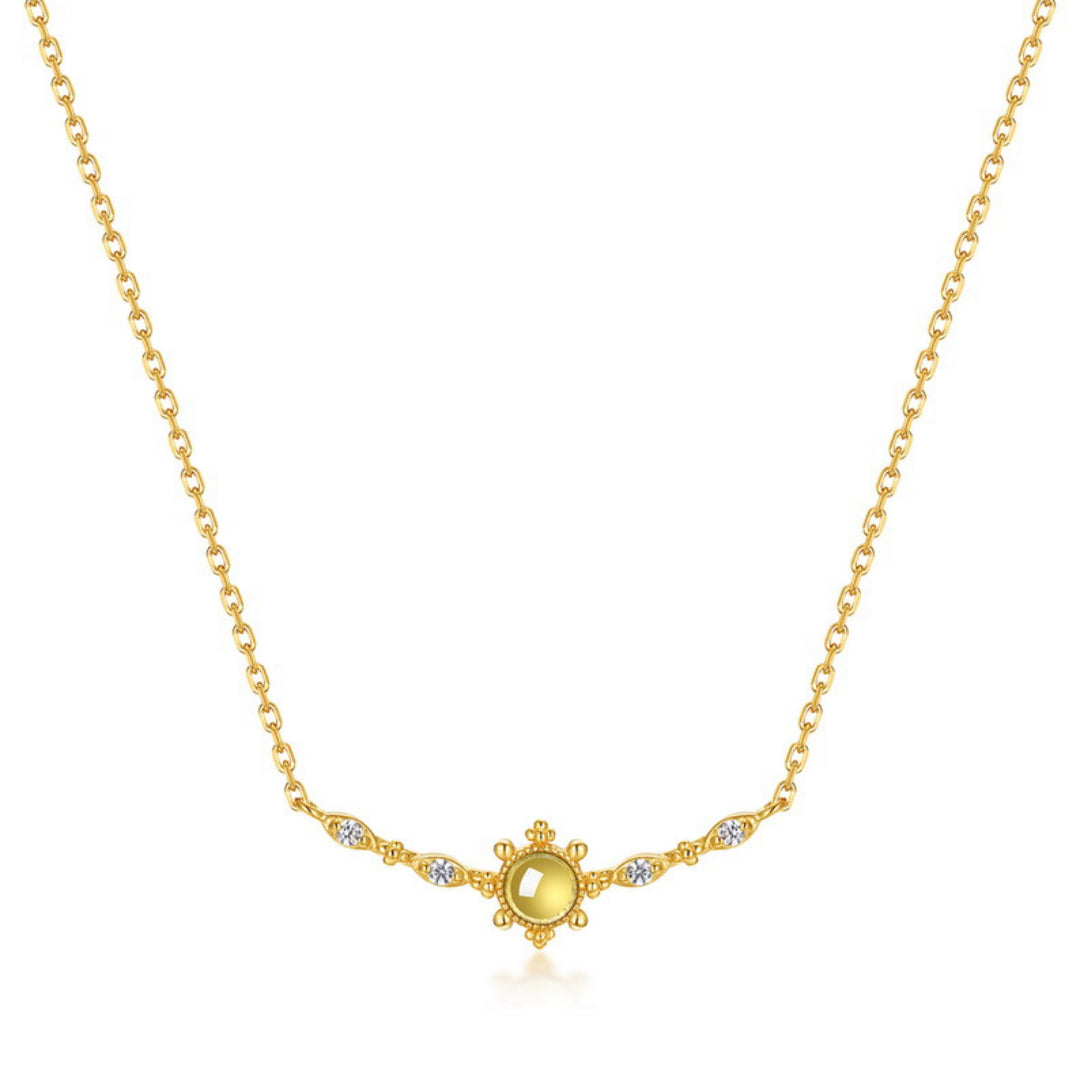 Collier en argent plaqué or avec un pendentif central rond en péridot entouré de petits zircons blancs et d'une chaîne délicate.