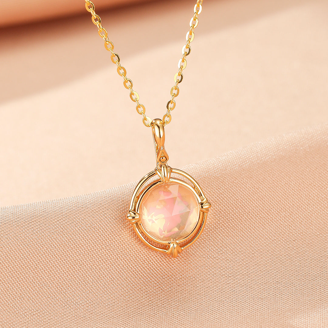 Collier "Aura Radieuse" en argent plaqué or 10K avec un pendentif rond en quartz rose aux reflets changeants, monté sur une chaîne délicate.