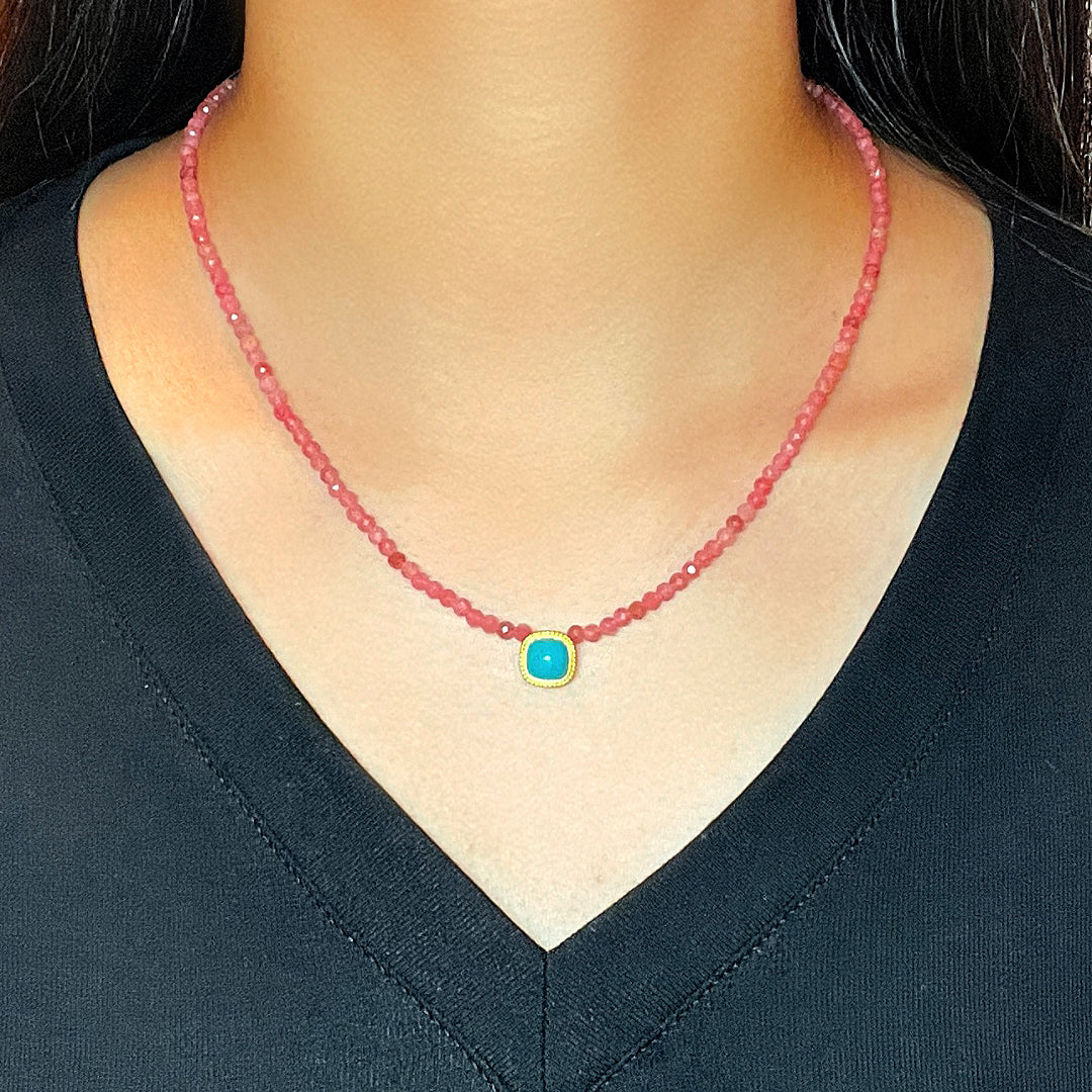 Collier fin en pierres roses avec un pendentif carré bleu turquoise serti dans de l'or jaune.