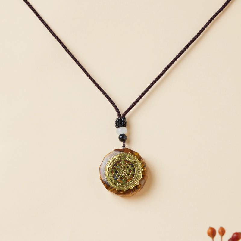 Pendentif rond en œil de tigre avec symbole sacré Sri Yantra doré et cordon réglable.