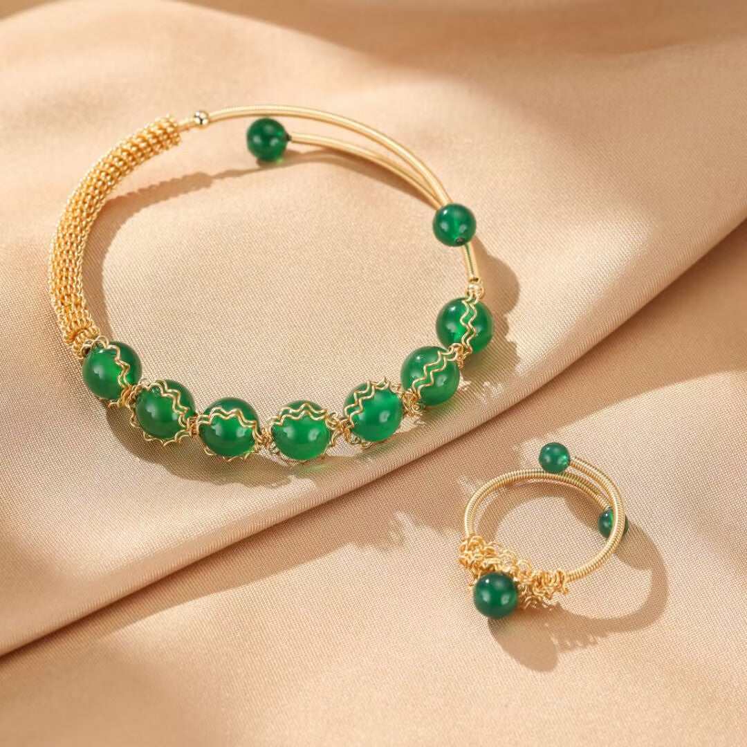 Ensemble de bijoux en argent plaqué or avec des perles d'agate verte, y compris un bracelet et une bague, symbolisant l'énergie et la vitalité.