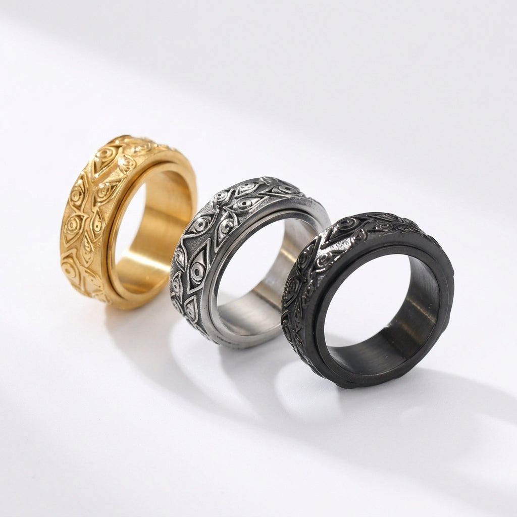 Trois bagues pour homme Force Urbaine en acier inoxydable avec motif d'yeux gravés, disponibles en coloris doré, argenté et noir.