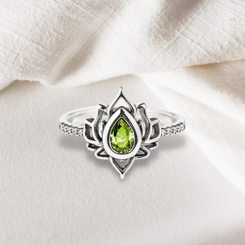 Bague Lotus Le Renouveau en argent 925 ornée d'une pierre verte en forme de goutte et de petits zircons sur l'anneau.