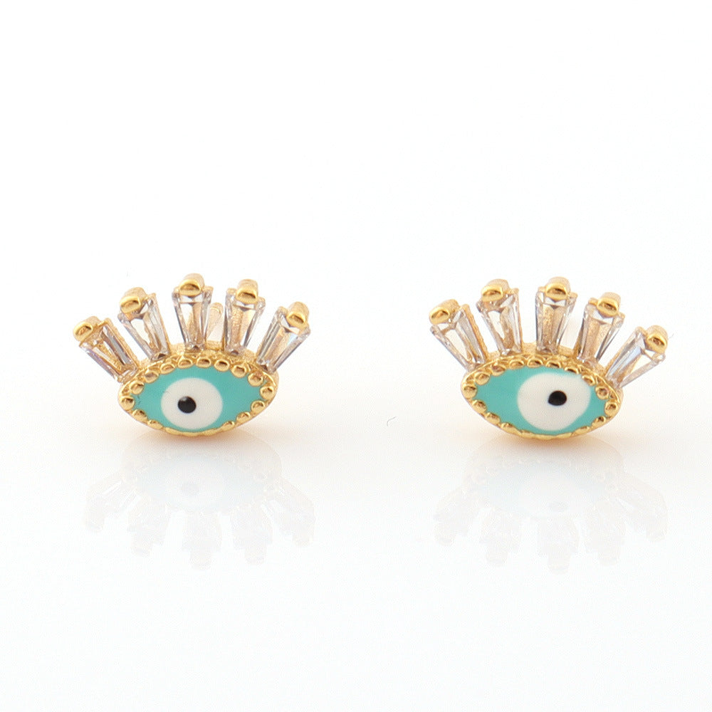 Boucles d’oreilles œil stylisé en laiton doré et émail bleu turquoise avec cristaux transparents pour femme