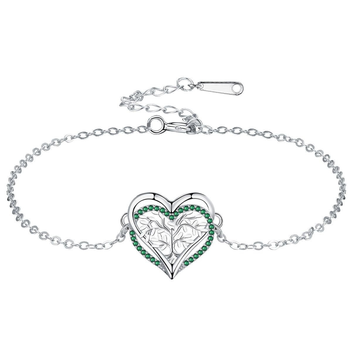 Bracelet en argent avec un pendentif en forme de cœur gravé d'un arbre de vie stylisé et bordé de pierres vertes.