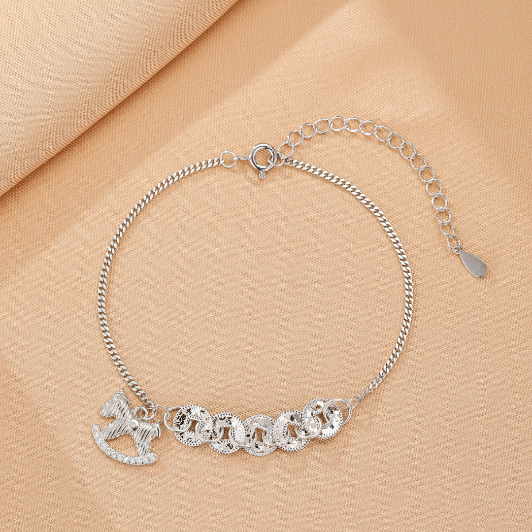 Bracelet en argent avec un charm de cheval à bascule orné de strass et de cinq breloques rondes