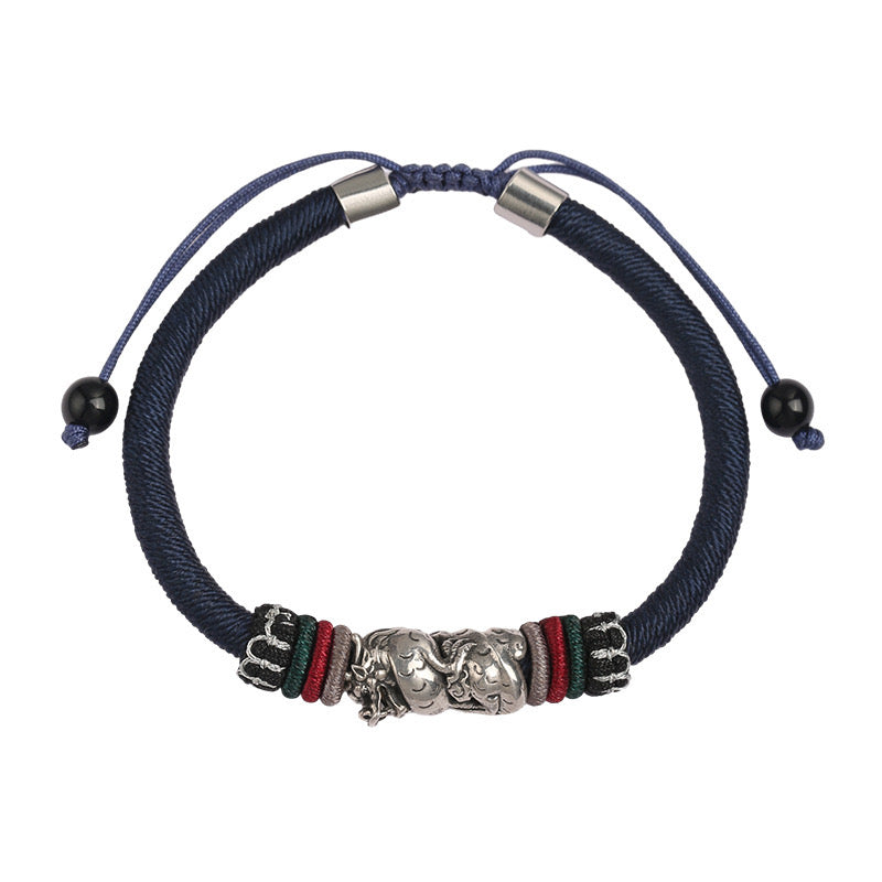 Bracelet cordon bleu avec un pendentif dragon en argent et des perles noires