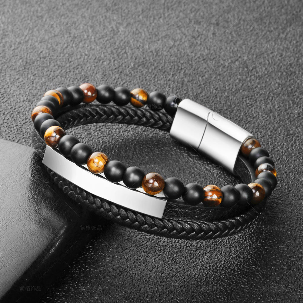 Bracelet homme en cuir tressé noir avec perles œil de tigre marron et noires, fermoir argenté et plaque métallique polie.