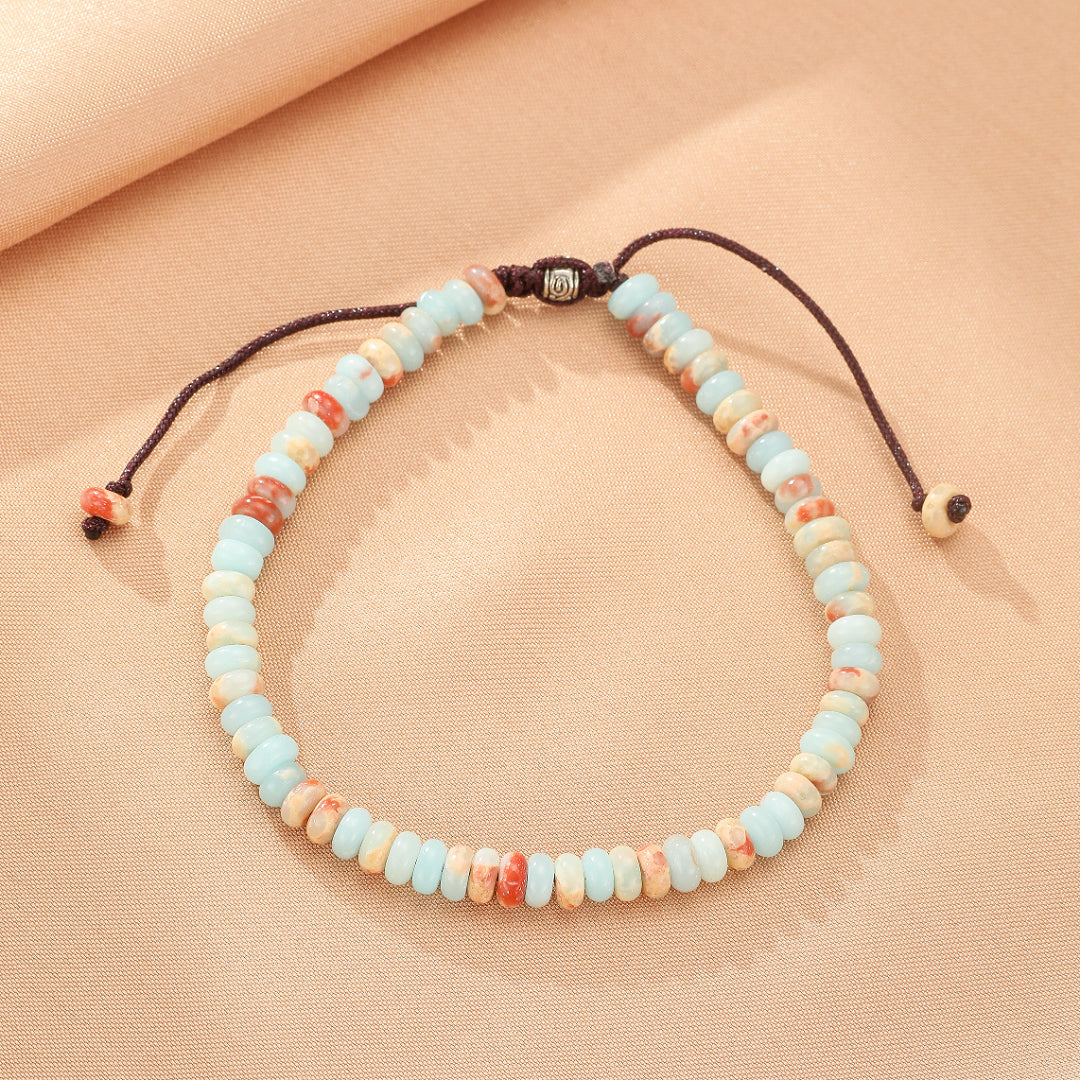 Bracelet en jaspe bleu ciel et corail avec cordon réglable marron, style bohème.