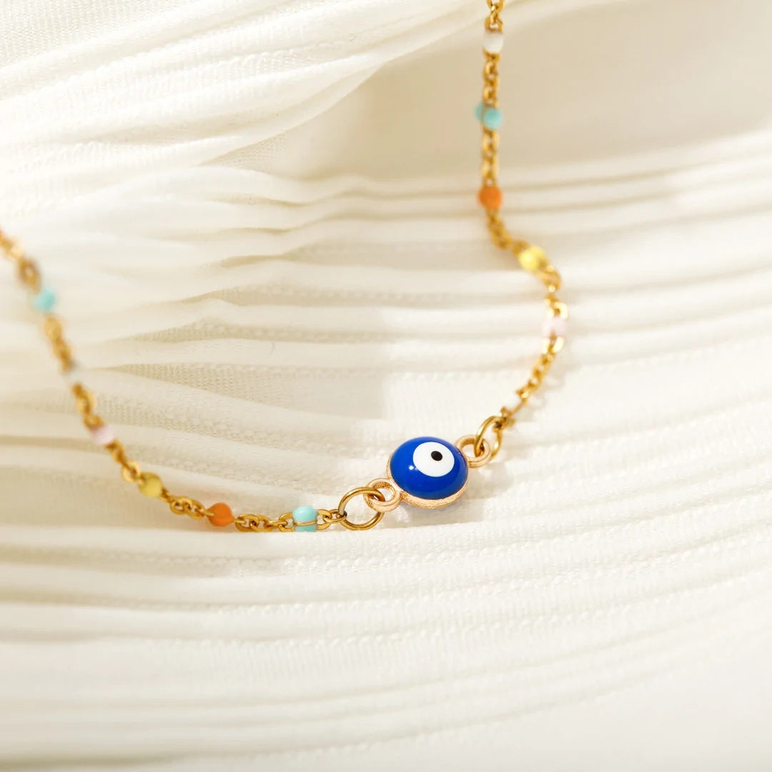 Bracelet fin en argent 925 avec un pendentif œil bleu et des petites perles colorées