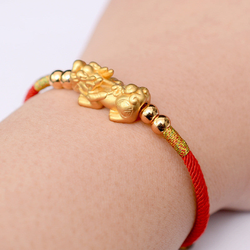 The "Mythique" accessory worn on the left wrist