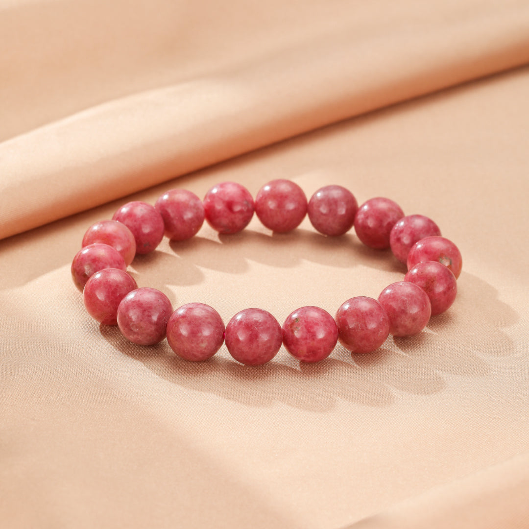 Bracelet en perles de rhodonite rose, un bijou de lithothérapie pour l'harmonie et l'amour de soi.