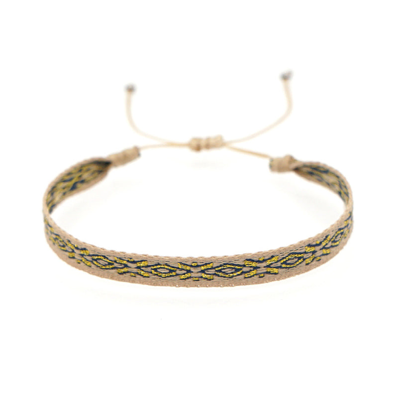 Bracelet Tibétain Trio en tissu beige avec motif ethnique doré et bleu, cordon ajustable