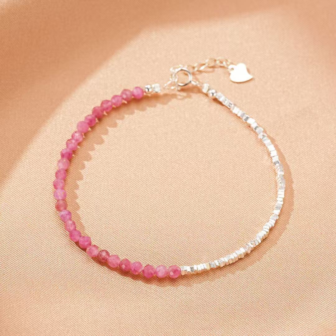 Bracelet en tourmaline rose intuitive et argent, orné d'une petite breloque en forme de cœur argenté.