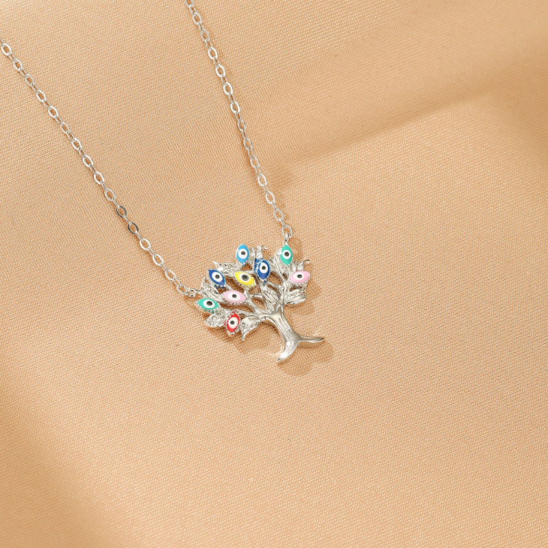 Collier Arbre de Vie "Éclat Céleste" en argent 925, orné de multiples "mauvais yeux" colorés et protecteurs.