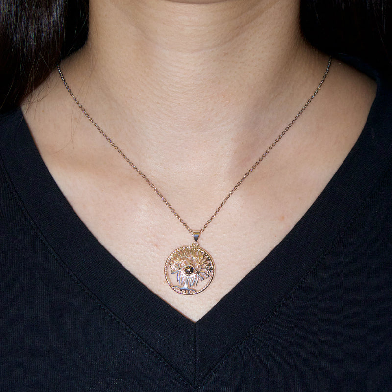 Collier Arbre de Vie en argent, porté par une femme, avec un pendentif rond représentant un arbre stylisé et des pierres scintillantes.