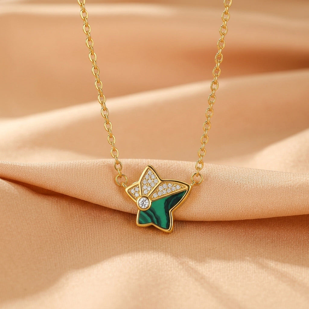 Collier en argent plaqué or avec un pendentif en étoile incrusté de malachite verte et de petits diamants brillants.