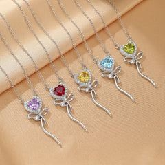 Colliers en argent plaqué or 18 carats avec pendentif cœur en pierres fines multicolores (améthyste, rubis, topaze, citrine, aigue-marine, péridot) et nœud en argent orné de cristaux.