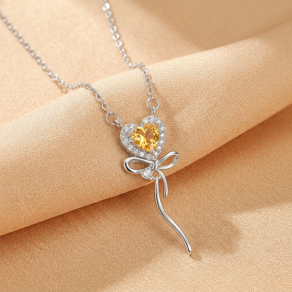 Collier en argent plaqué or 18k avec un pendentif en forme de cœur jaune entouré de zirconium et orné d'un nœud décoratif