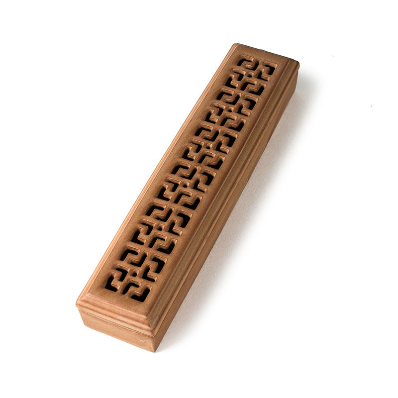 Encensoir rectangulaire en céramique de couleur bronze avec un motif ajouré sur le dessus