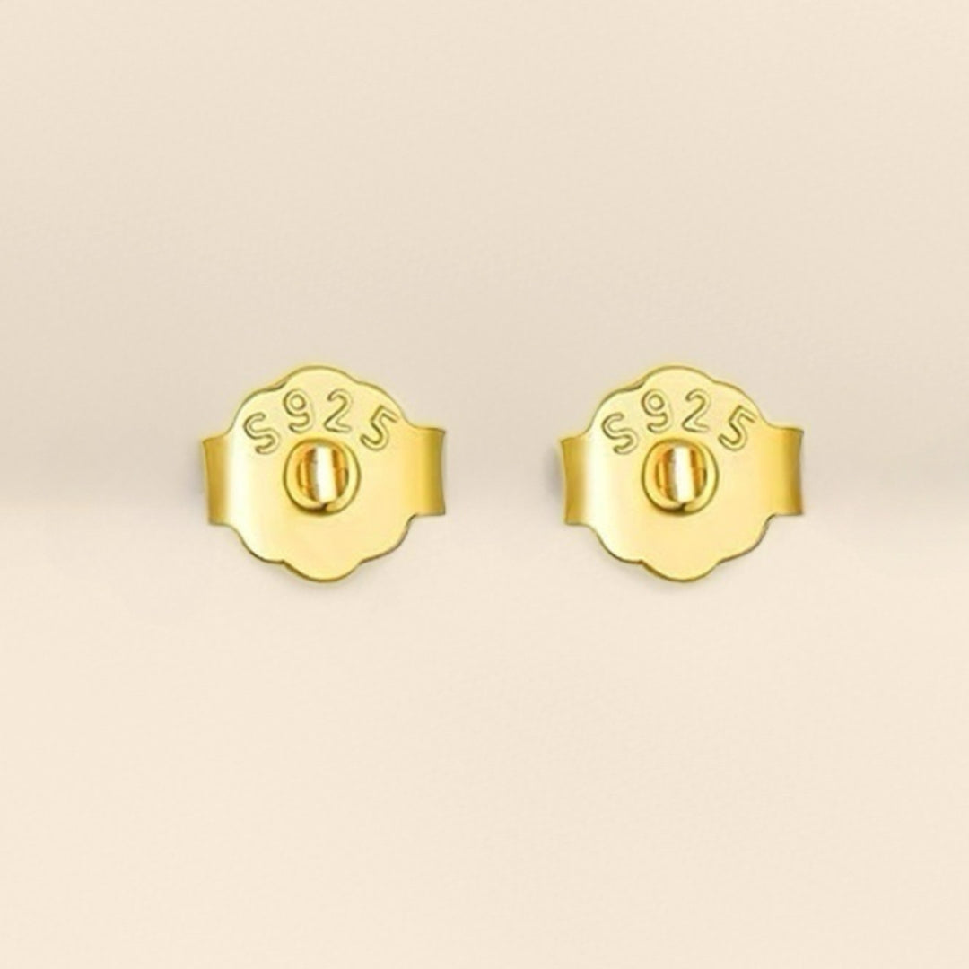 Poussoirs de boucles d'oreilles en argent 925, gros plan sur deux fermoirs dorés avec inscription S925